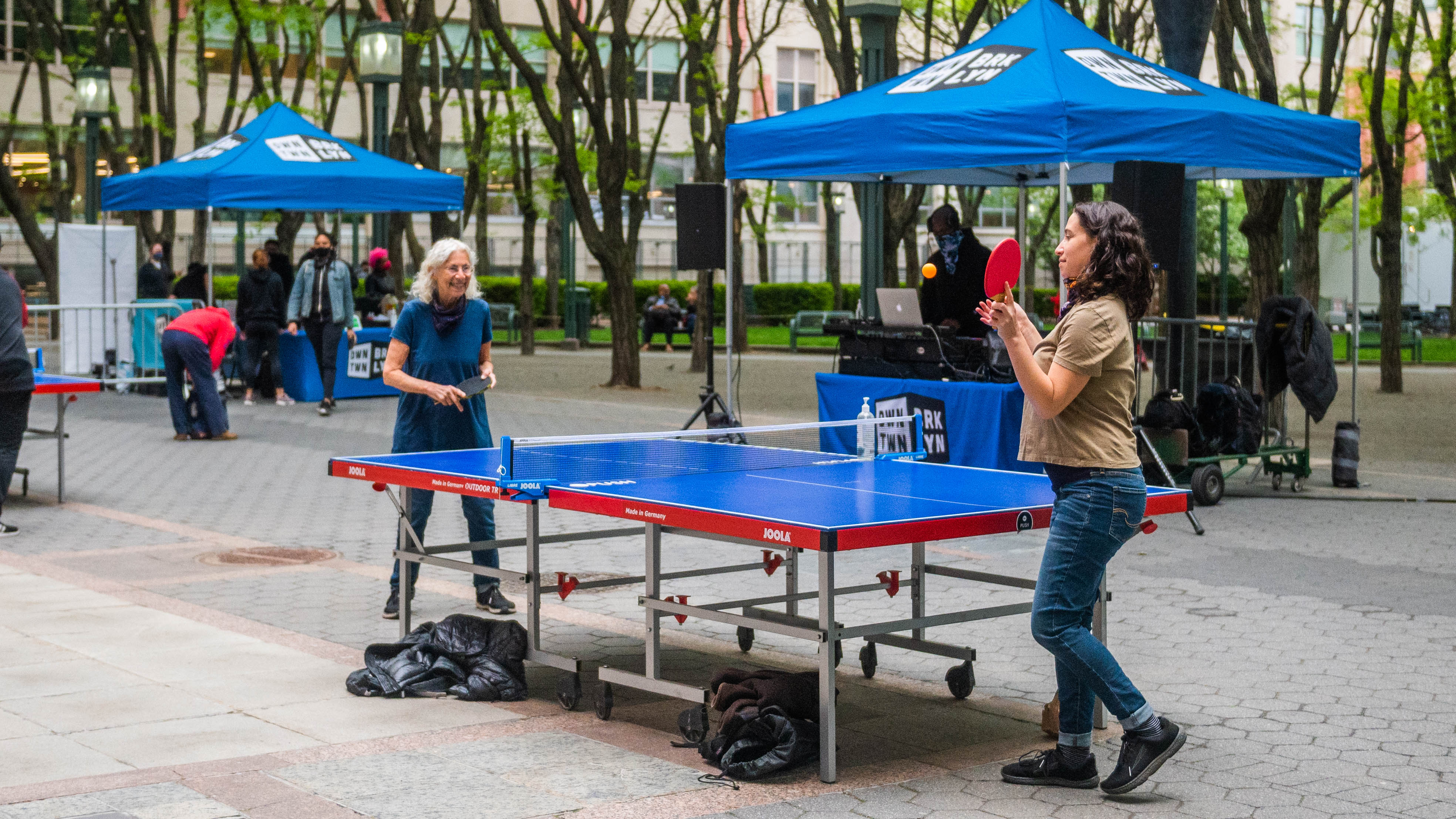 Two people play ping-pong.